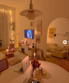 a laptop computer sitting on top of a table in a living room next to a couch