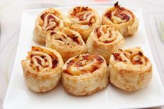 a white plate topped with rolls on top of a table