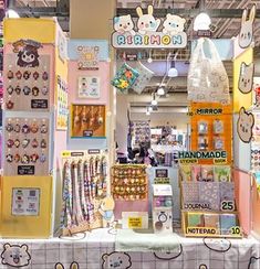 an assortment of items on display in a store with hello kitty stickers and posters