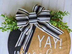 a wooden sign that says yay yourself with a bow hanging on the front door