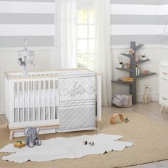 a baby's room with striped walls and furniture