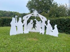 a nativity scene made out of paper in the grass