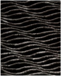 an abstract black and white background with wavy lines in the shape of waves on it