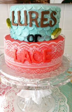 a cake that is on top of a glass plate and has the words lures or lace written on it