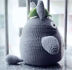 a crocheted stuffed animal sitting on top of a counter next to a window