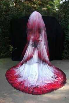 a woman in a white and red dress is standing on the ground with her back turned to the camera