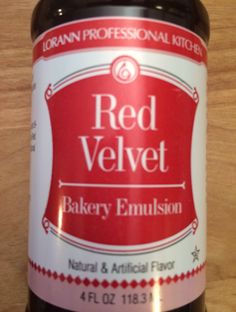 a bottle of red velvet bakery emulsion sits on a table top, ready to be used