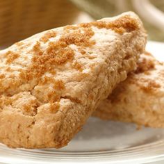 two pieces of bread on a plate with a basket in the backgrouf