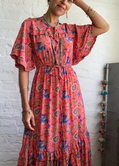 "This is cute easy to wear boho style long dress with wide flared sleeves and cute v neckline with tassel tie it is made free size with high waist and strap tie to fit most of sizes MEAESURE shoulder 17\" bust 40\" Elastic high waist up to 36\" length 55\" MATERIAL *poliester *no lining More boho style ideas at https://www.etsy.com/shop/AltheaStores? CARE INSTRUCTIONS * Wash in warm water * Hand wash recommended * Hang to dry IMPORTANT NOTE * Please note that colour shown on your monitor may var Bohemian V-neck Wrap Dress For Brunch, Bohemian V-neck Dress With Tie Waist, Flowy Rayon Midi Dress With Ruffle Hem, Bohemian Rayon Maxi Dress With Ruffles, Bohemian V-neck Maxi Dress For Brunch, Flowy V-neck Dress For Festival, Flowy V-neck Festival Dresses, Bell Sleeve Ruffled Dresses For Vacation, Flowy Rayon Dress With Ruffle Hem