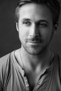 a black and white photo of a man wearing a necklace