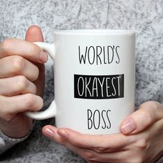 a person holding a coffee mug with the words world's okayest accountant on it