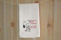 a towel hanging on a clothes line with the words laugh at your problems they didn't see across