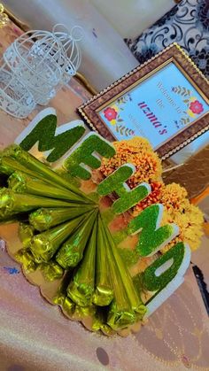 there is a cake decorated with green leaves and flowers