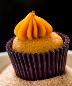 there is a cupcake with orange slices on top