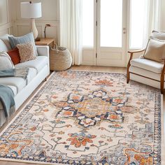 a living room filled with furniture and a large rug