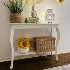 a white shelf with some flowers and vases on it