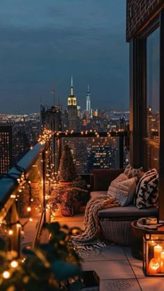 a balcony with candles lit on the floor and city lights in the background at night