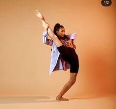 a woman is dancing in an orange background