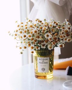 a vase filled with white flowers on top of a table