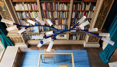 an overhead view of a room with bookshelves and chairs