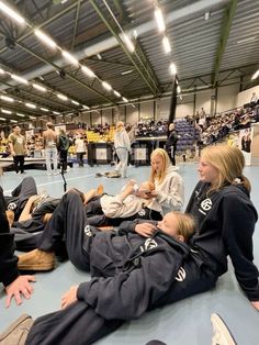 some people are laying on the floor in a gym