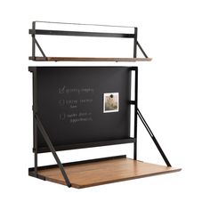 a blackboard with some writing on it and a wooden shelf next to the chalk board