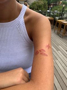 a woman with a small tattoo on her arm