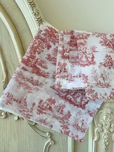 red and white toiler printed napkins sitting on top of a chair