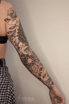 a woman's arm with flowers on it