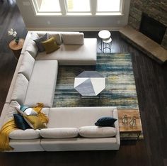 an aerial view of a living room with couch, coffee table and fireplace in it