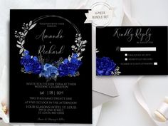 wedding set with blue flowers and leaves on black paper, in front of white envelope