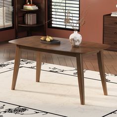 a wooden table sitting on top of a white rug