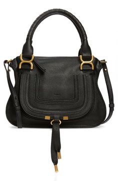 A cult-classic bag with equestrian-inspired styling, this calfskin satchel features wrapped top handles, topstitched accents at the flap and gleaming hardware. Swingy tassels and a removable shoulder strap complete the just-right bag. Top zip closure Rolled top handles; removable, adjustable shoulder strap Slip pocket beneath exterior flap Interior zip and wall pockets Lined Leather Made in Italy Designer Handbags This brand has B Corp certification, representing business practices with emphasis Black Calf Leather Satchel With Gold-tone Hardware, Classic Saddle Bag With Top Handle And Branded Hardware, Fall Workwear Satchel With Handles, Fall Workwear Satchel, Calf Leather Satchel With Branded Hardware, Leather Top Handle Satchel With Branded Hardware, Leather Saddle Bag With Gold-tone Hardware And Double Handle, Classic Saddle Bag With Gold-tone Hardware And Double Handle, Calf Leather Satchel With Handles For Work