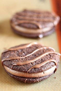 two cookies with frosting on them sitting on a table