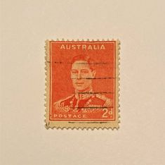 an orange stamp with the image of a man in uniform on it's side