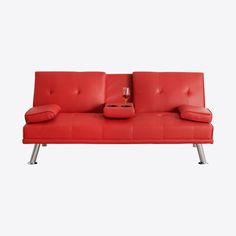 a red couch sitting on top of a metal frame