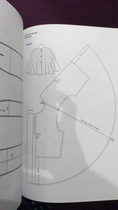 an open book with drawings on it and the pages cut out to look like circles