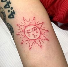 a sun and moon tattoo on the arm