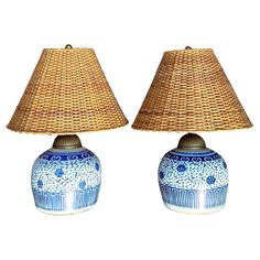 two blue and white vases with lamps on them