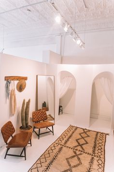 a room filled with lots of different types of furniture and rugs on the floor