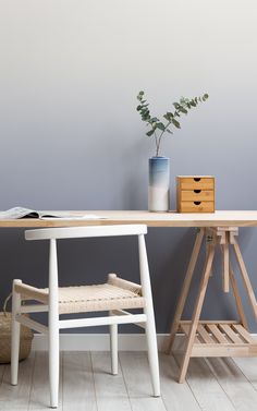 a wooden desk with a plant on it