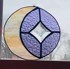 two circular stained glass pieces sitting on top of a window