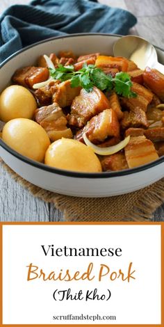 a bowl filled with meat and vegetables on top of a wooden table