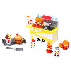 a toy kitchen set with food and cooking utensils