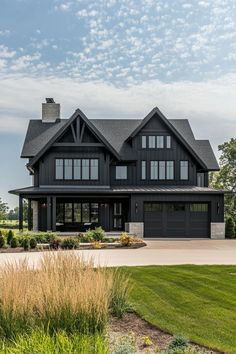 a large black house with lots of windows on the front and side of it's roof