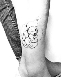 a small bear tattoo on the ankle