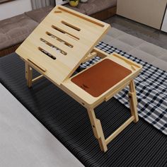 a small wooden table with a laptop on it's top and a tray underneath