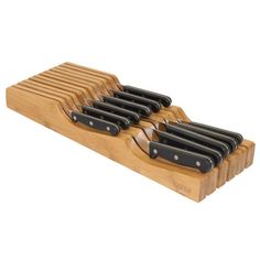 a wooden knife holder with six knives in it