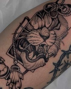 a black and white tiger tattoo on the arm