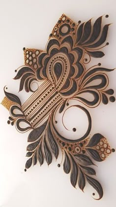 an intricately designed piece of wood on a white surface